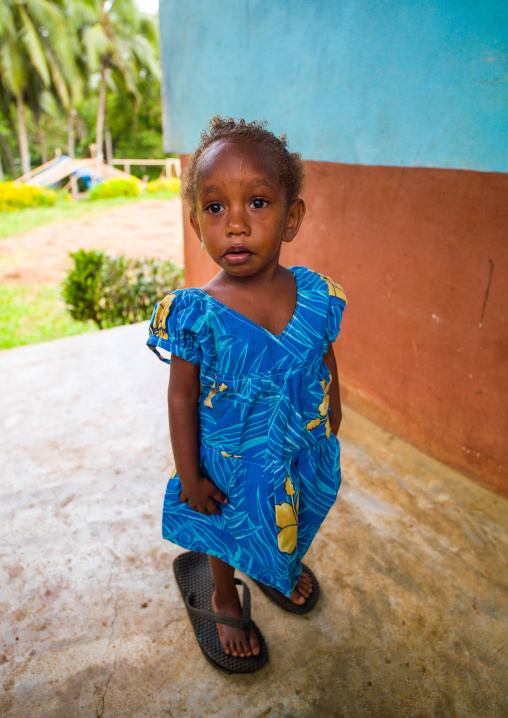 Portrait of a Ni-Vanuatu girl walking with shoes too big for her, Malampa Province, Malekula Island, Vanuatu