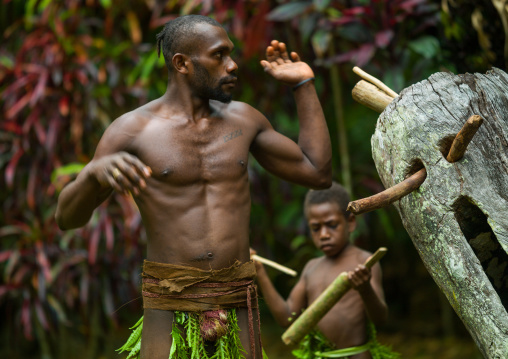 Big Nambas tribesman beating a slit drum during a ceremony, Malampa Province, Malekula Island, Vanuatu