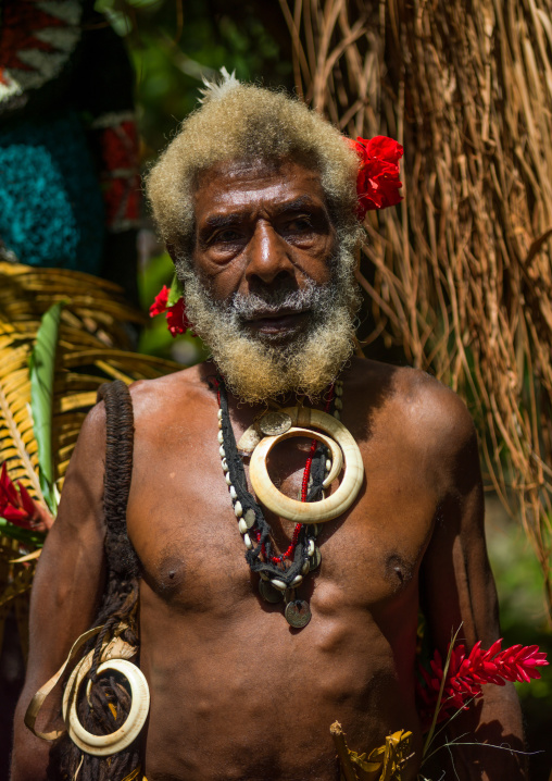 Portrait of chieftain Etul on the Rom dance area in front of a giant slit drum, Ambrym island, Fanla, Vanuatu