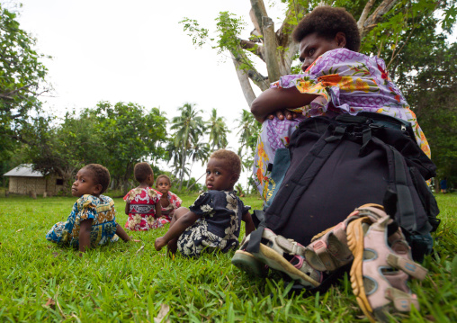 Mother and her children resting in the grass, Malampa Province, Ambrym island, Vanuatu