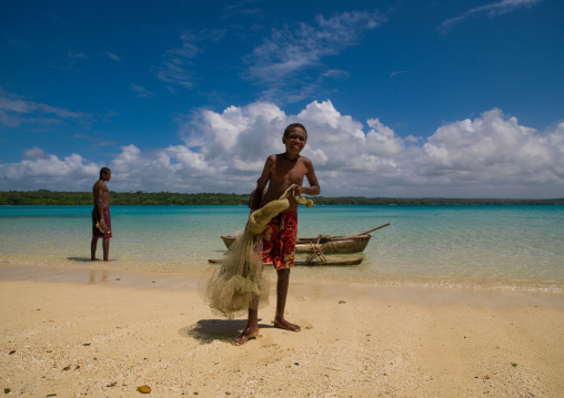 Young boys of the Ni-Vanuatu people with their dugout and fishing net, Sanma Province, Espiritu Santo, Vanuatu