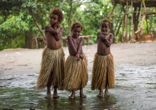 Three girls in traditional grass skirts, Tanna island, Yakel, Vanuatu