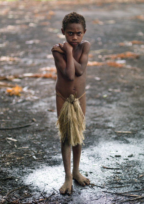 Boy wearing a penis sheath called a namba suffering from the cold, Tanna island, Yakel, Vanuatu