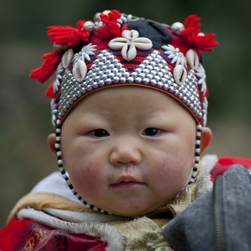 Red dzao baby with a traditional hat, Sapa, Vietnam