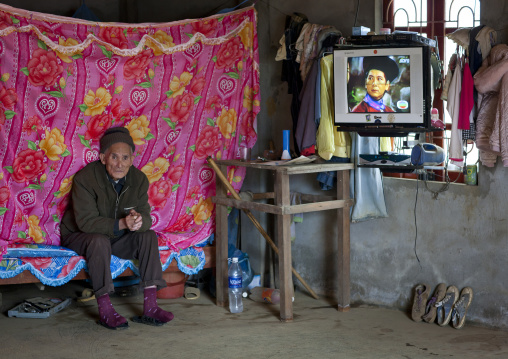 Old giay man with tv in his room, Sapa, Vietnam