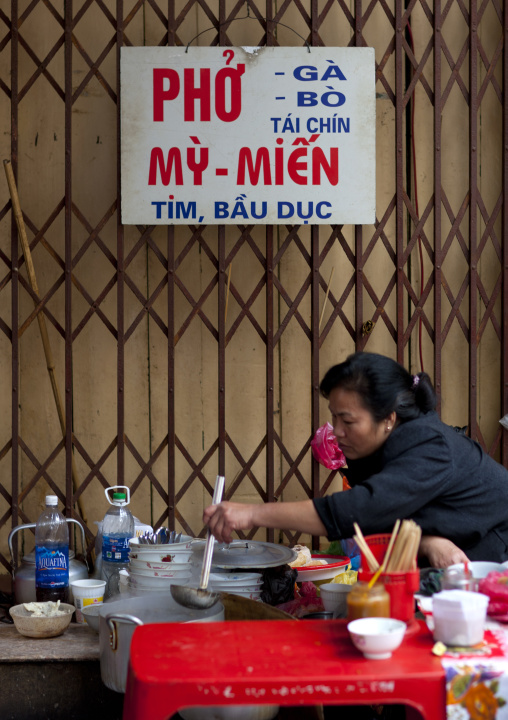 Woman eating in a restaurant, Hanoi, Vietnam