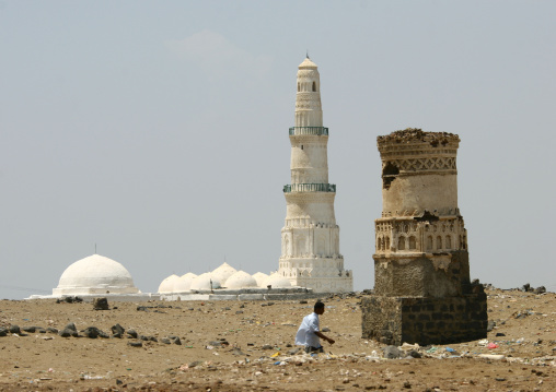 Man Passing By The Remains Of A Tower With A White Mosque In The Background, Mocha, Yemen