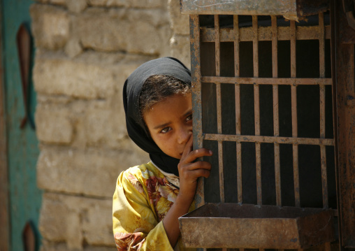 Shy Yemeni Girl Hiding Behind An Iron Door, Shahara, Yemen