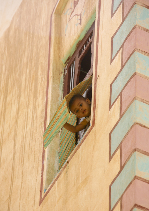 Boy Looking Out From The Window Of A Traditionally Painted Building, Wadi Doan, Yemen