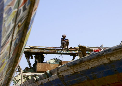 Young Man Sitting On The Top Of A Dhow, Al Hodeidah Harbour, Yemen