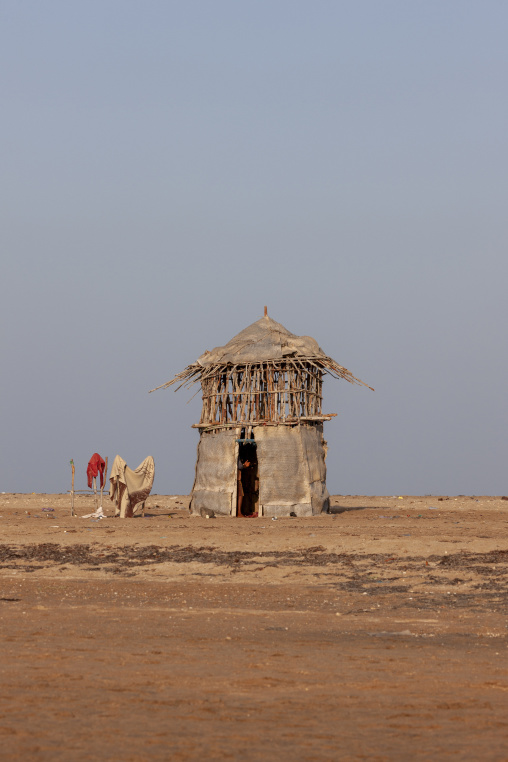 A traditional straw hut stands alone in the desert, Obock Region, Gorodia, Djibouti