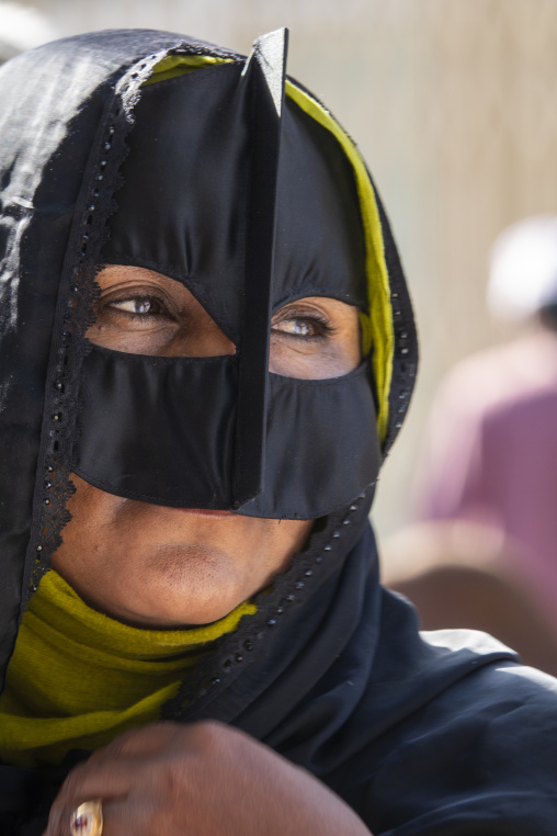 Close-up portrait of a woman wearing a black traditional burqa face mask and an olive green headscarf, Ad Dakhiliyah Region, Nizwa, Oman