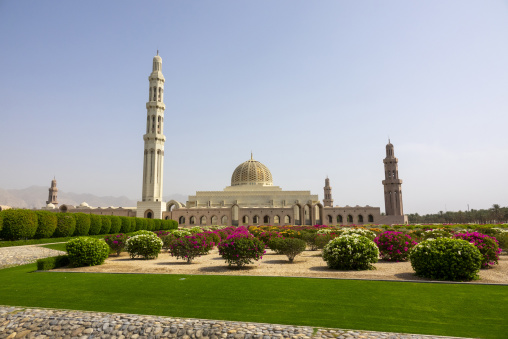 Wide view of the Sultan Qaboos Grand Mosque with its golden dome and minarets surrounded by gardens, Governorate of Muscat, Muscat, Oman