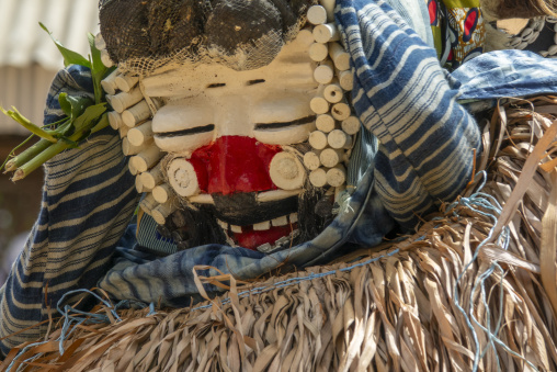 A white-painted wooden mask with a red mouth performs during a We Guere sacred dance ceremony, Guémon, Bangolo, Ivory Coast