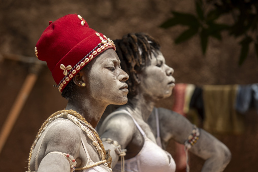 Two women covered in white clay perform during the Adjoua Messouma Komians initiation ceremony, Moyen-Comoé, Aniassue, Ivory Coast