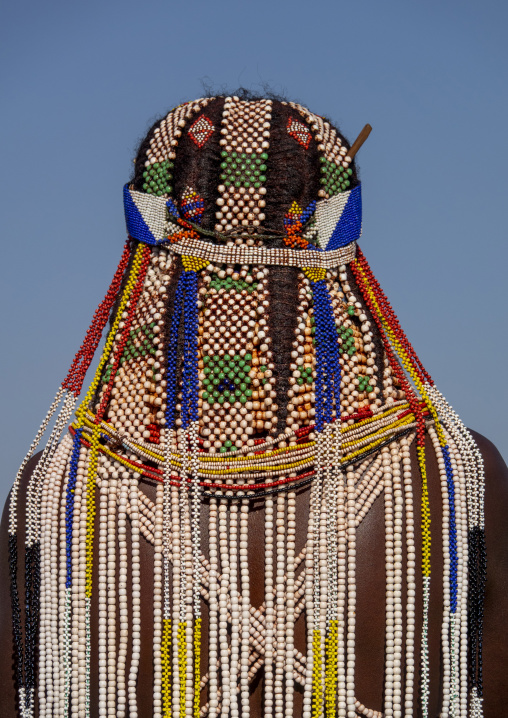 Close-up back view of a Handa woman's braided hair decorated with colorful beads, Huila Province, Hoque, Angola