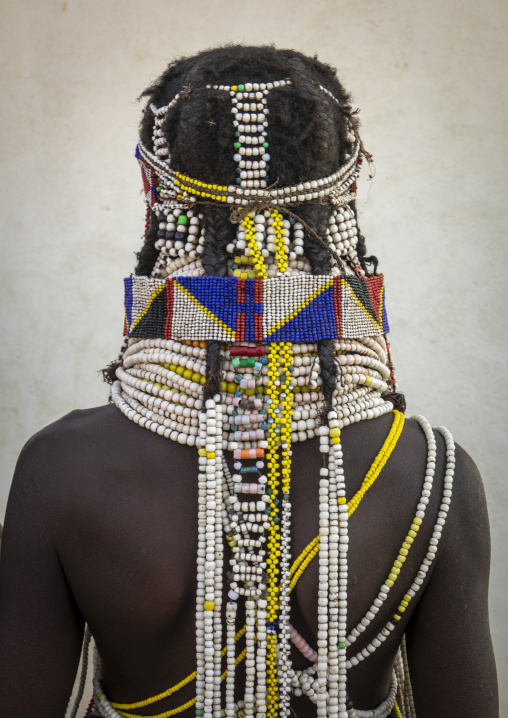 Back view of a Handa woman wearing a wide beaded collar and layered necklaces, Huila Province, Hoque, Angola