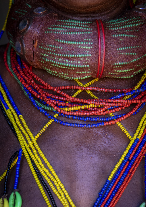 Close-up of a Mungambue woman's clay-coated hair roll and layered beaded necklaces, Huila Province, Chibia, Angola