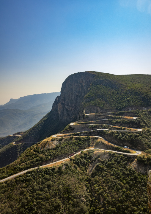 Aerial view of the winding hairpin road descending Serra da Leba with buses climbing the switchbacks, Huila Province, Humpata, Angola