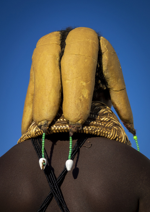 Close-up rear view of a Mwila woman's ochre-coated hair rolls resting on a woven leather headpiece, Huila Province, Lubango, Angola