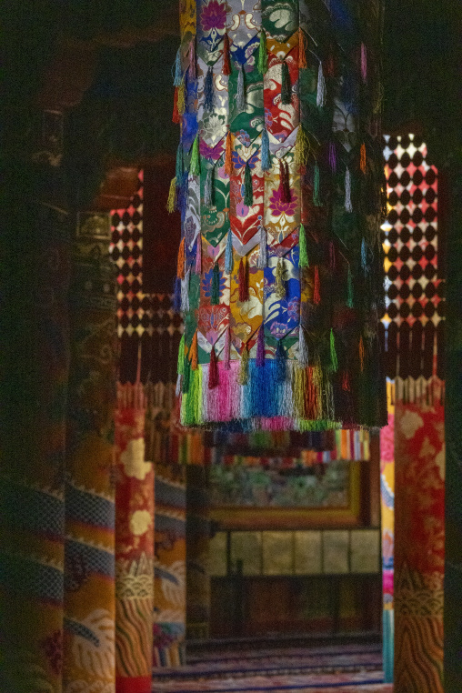 Ornate silk brocade decorations hanging inside Longwu monastery, Tongren County, Longwu, China