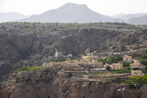 Terraced mountain village perched on a cliff edge surrounded by rugged peaks, Jebel Akhdar, Sayq, Oman