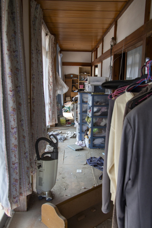 Interior of an abandoned house filled with scattered belongings