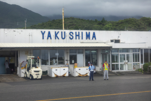 Ground crew and forklift in front of the Yakushima airport termi